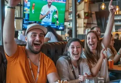 Establishment customers enjoying a day of fun live sports and their favorite food